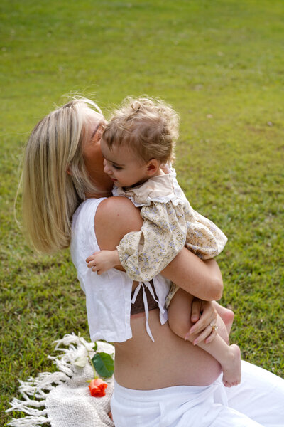 mum holding daughter laughing