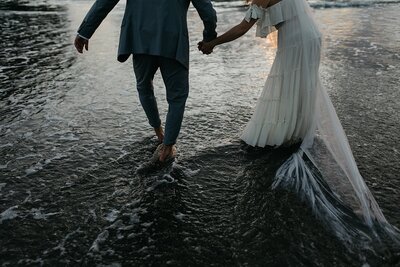 Photo of a couple during their shoot by the beach