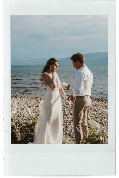 bride and groom exchanging vows while bride wipes away tear during lake tahoe california elopement by the water in polaroid frame