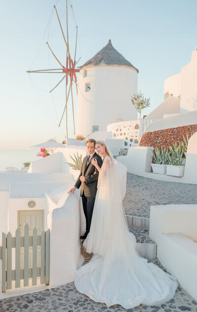 bride and groom facing towards the water at their wedding.