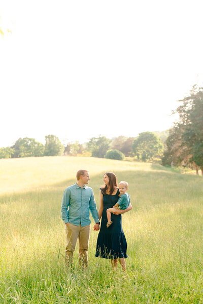 Mom, Dad, and son stand in a field in Knoxville, TN