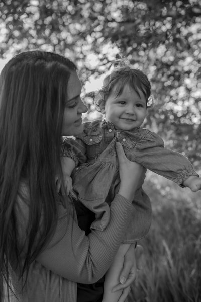 Outdoor family photoshoot in Omaha park during golden hour – capturing candid, heartfelt moments.