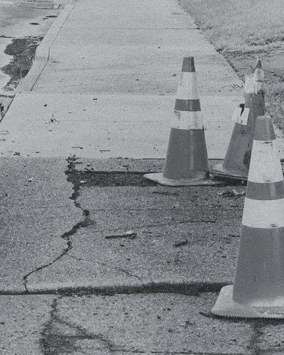 Traffic cones line a cracked sidewalk, representing the hesitation and self-doubt explored in the “I Don’t Trust Myself” Learning Path from CPTSD Medicine.