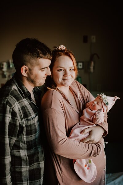 Mom and dad holding newborn baby in El Paso Hospital.