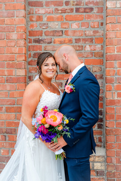Bride and groom looking at each other sharing an intimate moment before their wedding.