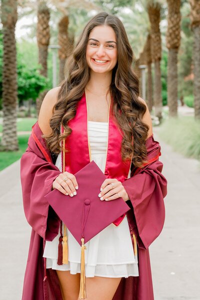 ASU graduate posing in the north scottsdale desert for her senior photos
