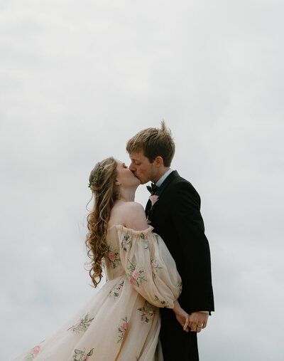 A couple holds hands during their Oregon coast engagement photos. 