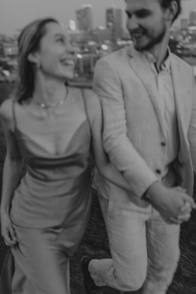 blurry black and white couple running in love anniversary photo