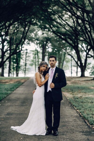 Destination wedding photography by Britt Elizabeth captures a heartwarming image of a bride and groom kissing on the street.