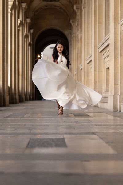 Model elegantly strolls the streets of Paris in a wedding gown, exuding grace and charm
