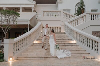 Couple walking down the stairs to their Jamaica Wedding