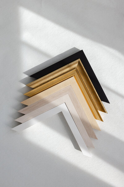 A selection of elegant frame corners in black, gold, white, and wood tones, offered by Suzanne Karp in  Little Palm Photography for wall art prints.