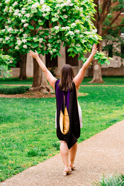 Vanderbilt Law senior raising hands in victory as she walks away