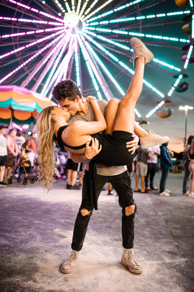 Sharing a kiss in front of the ferris wheel at their couples session at the Saratoga County Fair.