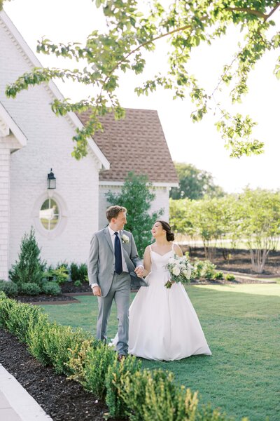 Bride and groom holding hands and wlking away grom the chapel