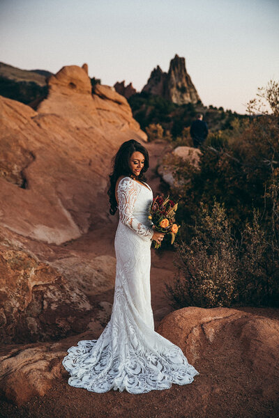 bride approaches groom for first look at garden of the gods in colorado 