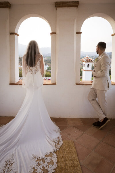 Bride and groom standing at the top of a tower at their Marbella wedding venue