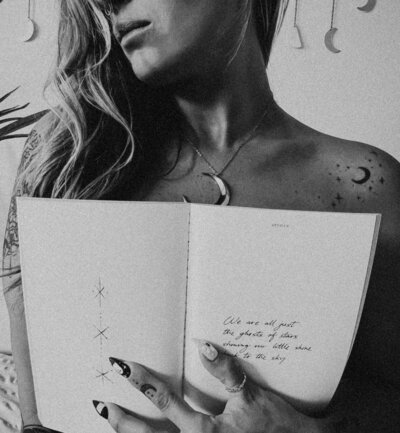 Black and white photo of Kate Boggs holding a journal.