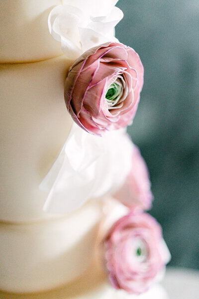 White wedding cake with pink floral details