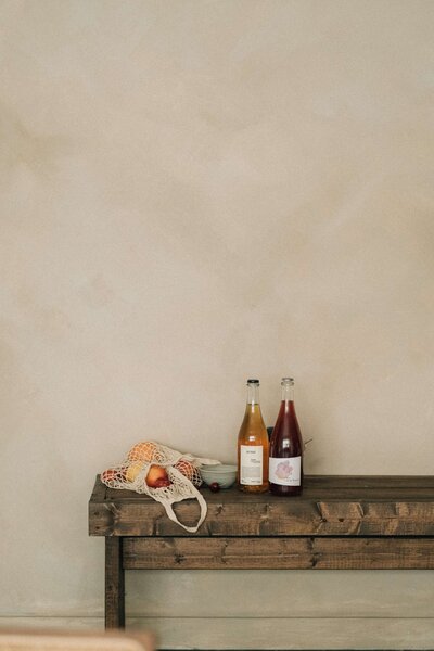 Rustic entry bench against plaster wall at West Vancouver renovation