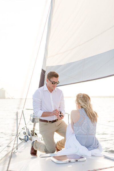 Man proposing on a sailboat at sunset