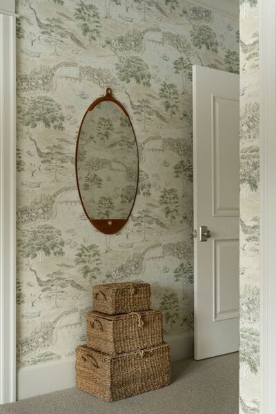 A room featuring a mirror on the wall and a basket placed on the floor, creating a serene and organized atmosphere.