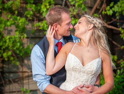 bride brings grooms face toward her for a kiss