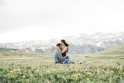 man and woman kissing in the rocky mountain fields