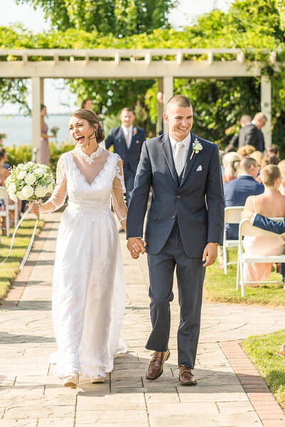 Bride and groom walking down aisle after ceremony holding hands