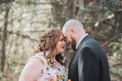 Couple looking at each other lovingly while the bride holds her bouquet at Platte River State Park in Lincoln, Nebraska.