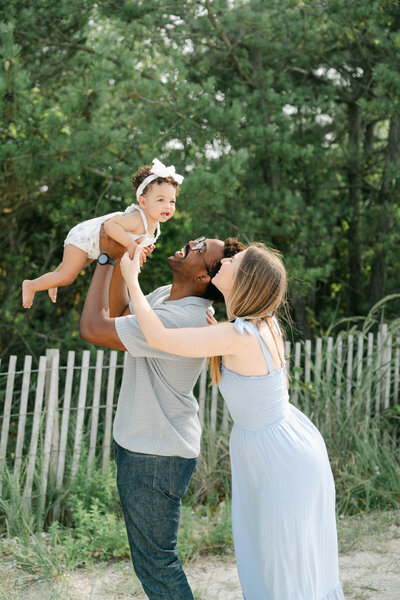 multi-racial  family cuddles at the beach in Delaware