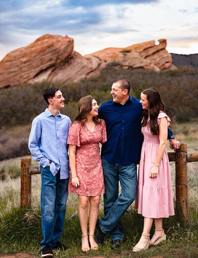 A family of four looks at each other during family photos at South Vally Park in Littleton, Colorado.