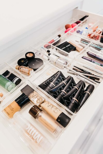 A bathroom drawer featuring neatly organized beauty products