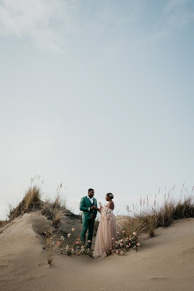 Bride and groom read each other private vows during their sand dunes elopement in Oregon