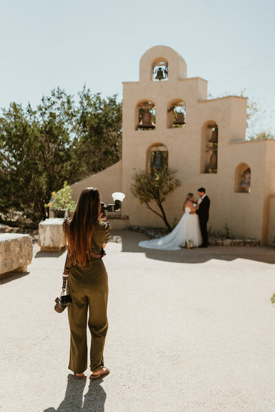 Behind the scenes of photographer capturing intimate moments of bride and groom during their first look at Chapel  Dulcinea in Austin TX