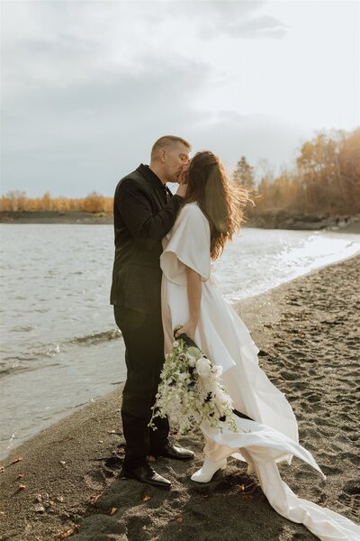 bride and groom on black beach