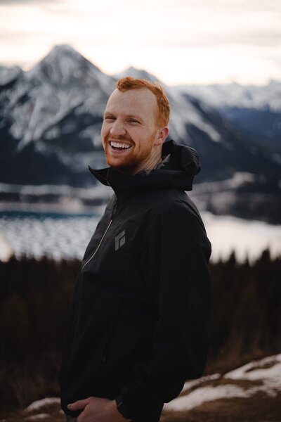 Wedding Photographer Connor Esau smiling in the Canadian Rockies near Calgary