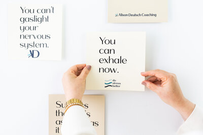 Hands arranging coaching cards with the phrase you can exhale now from Do Stress Better