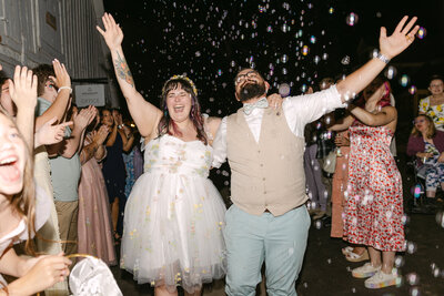 Fun bubble exit moment with newlyweds celebrating after their Colorado wedding reception