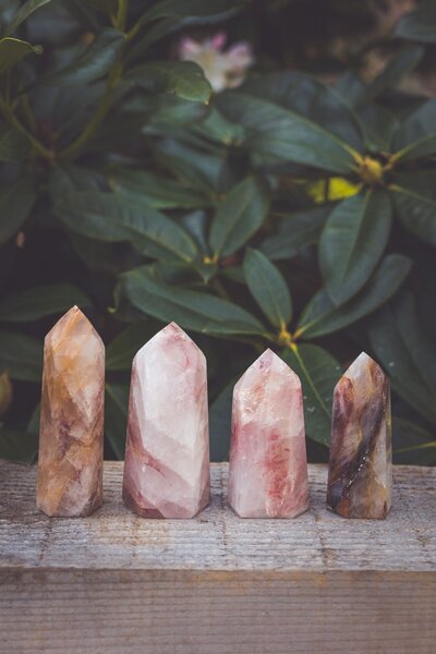 A collection of pink, orange, and brown golden healer crystal towers.
