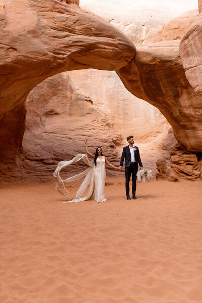 Moab Elopement couple in Arches National Park holding hands