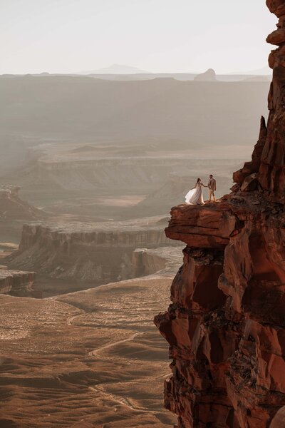 Bride and groom in epic landscape of canyonlands National Park