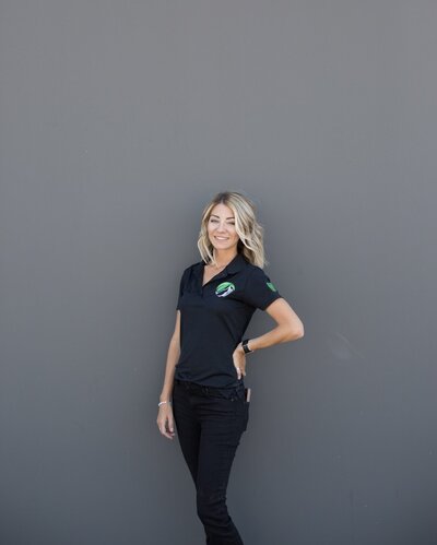 Everclear owner Amber Kraft wearing the official company uniform while standing in the wilderness.
