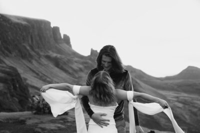 Bride eloping at sunrise on a cliff in scotland