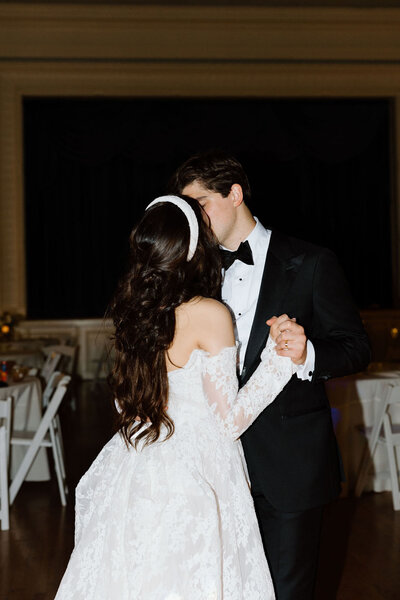 Bride and groom sharing a kiss during their first dance