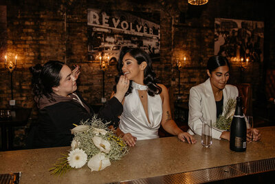 Makeup Artist Touching Up the Bride in a Chicago Bar