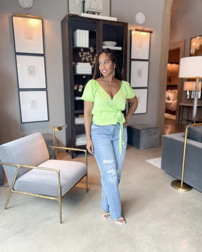 Josie Duncan standing in a hoe office wearing jeans and a green blouse.