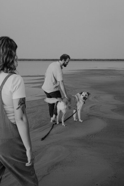 couple at the beach with their dog 