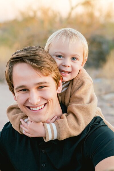 big brother and little brother posing for family photos in the north scottsdale desert