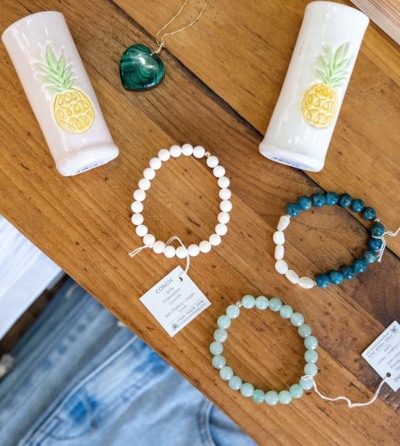 A table inside of Sacred Space Gallery in Key West, Florida displays fruit bowls, mugs, oil bottle and plates made by Jill Marie Pottery alongside other artwork by woman artists residing in Key West, FL